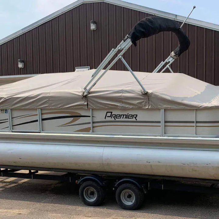 A pontoon with a cream colored cover