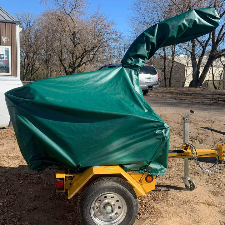 An orange woodchipper with a green color