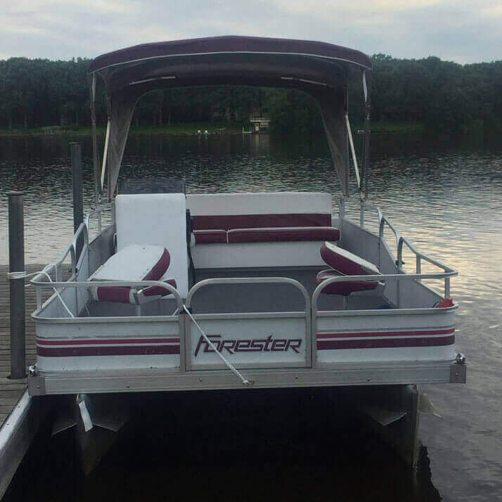 White pontoon with a maroon canopy